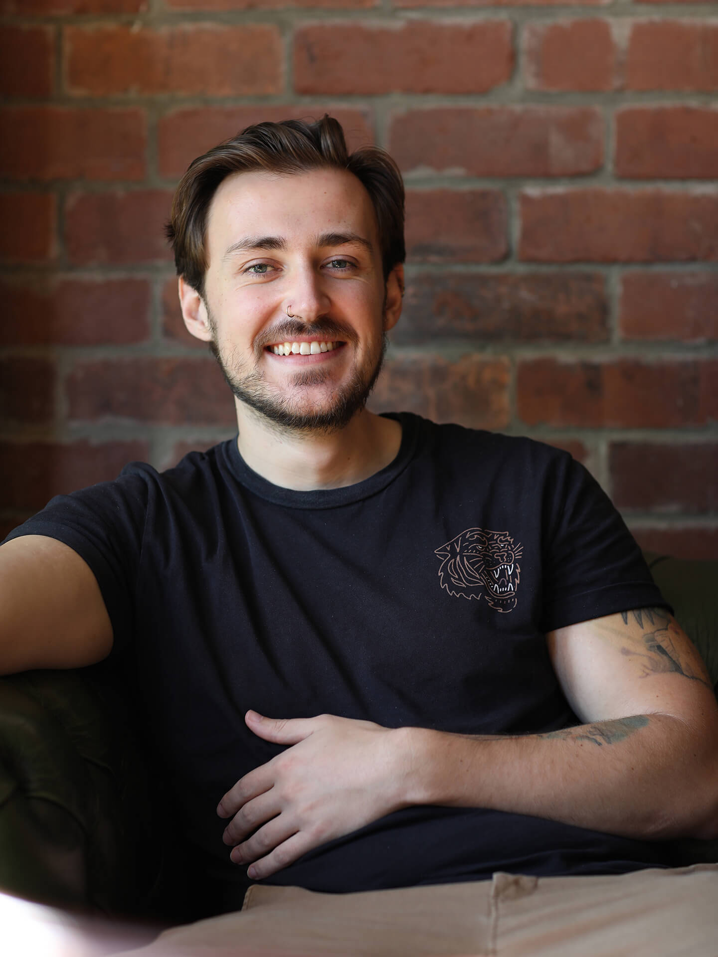 Harry Winship smiling whilst sitting on a chair