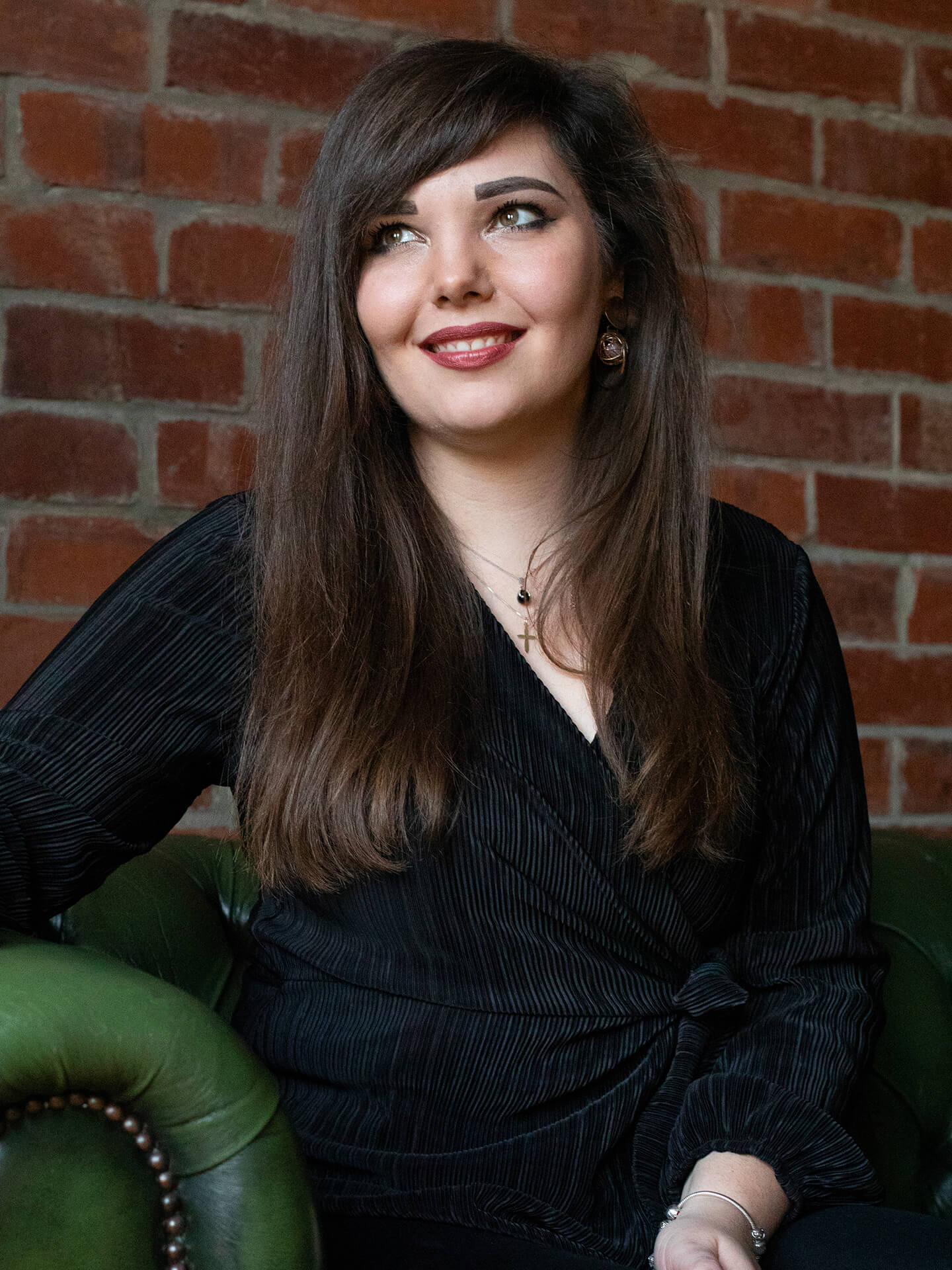 Rachel Taylor smiling whilst sitting on a chair